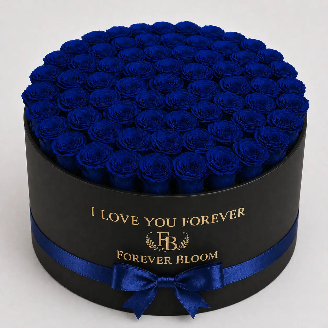 Blue roses in a round Black box with blue ribbon and 'Forever Bloom' branding.
