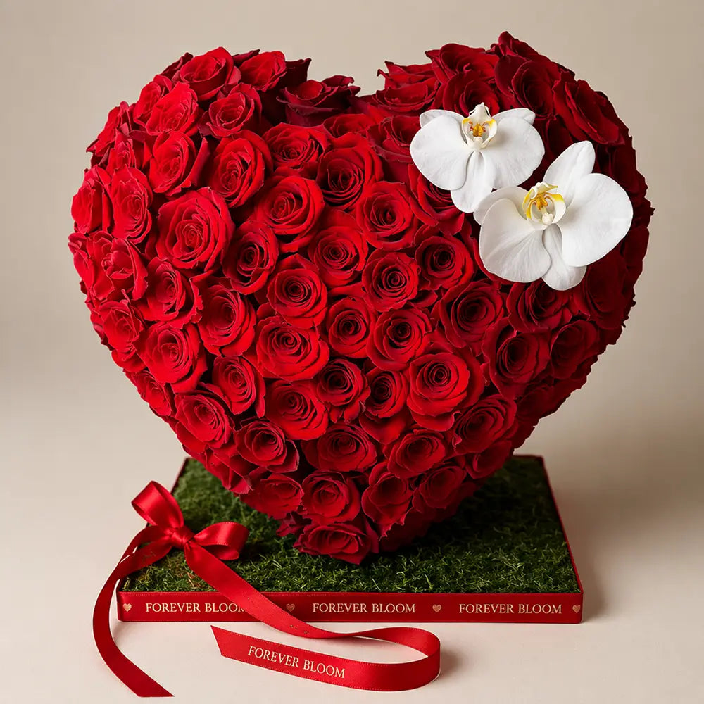Heart-shaped arrangement of red roses with white orchids on a beige background, branded 'Forever Bloom'.