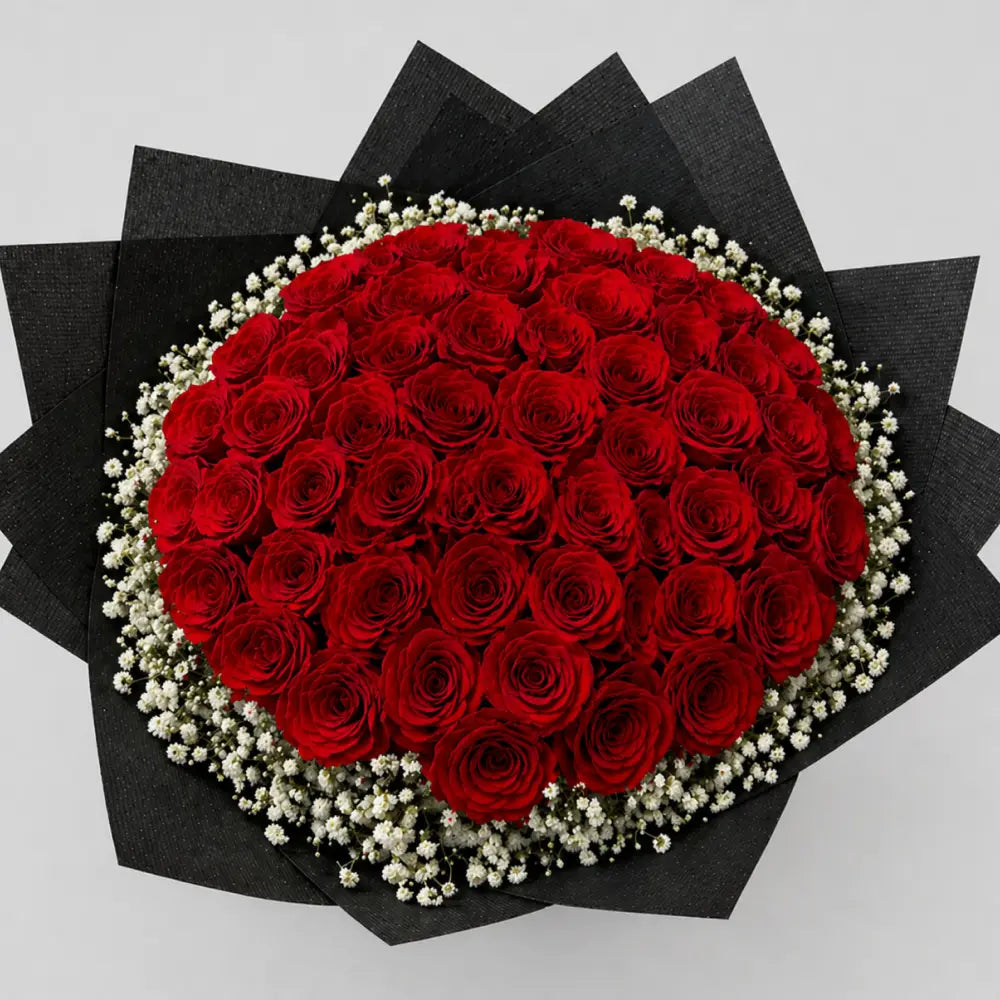 Bouquet of red roses with white accents on a black base