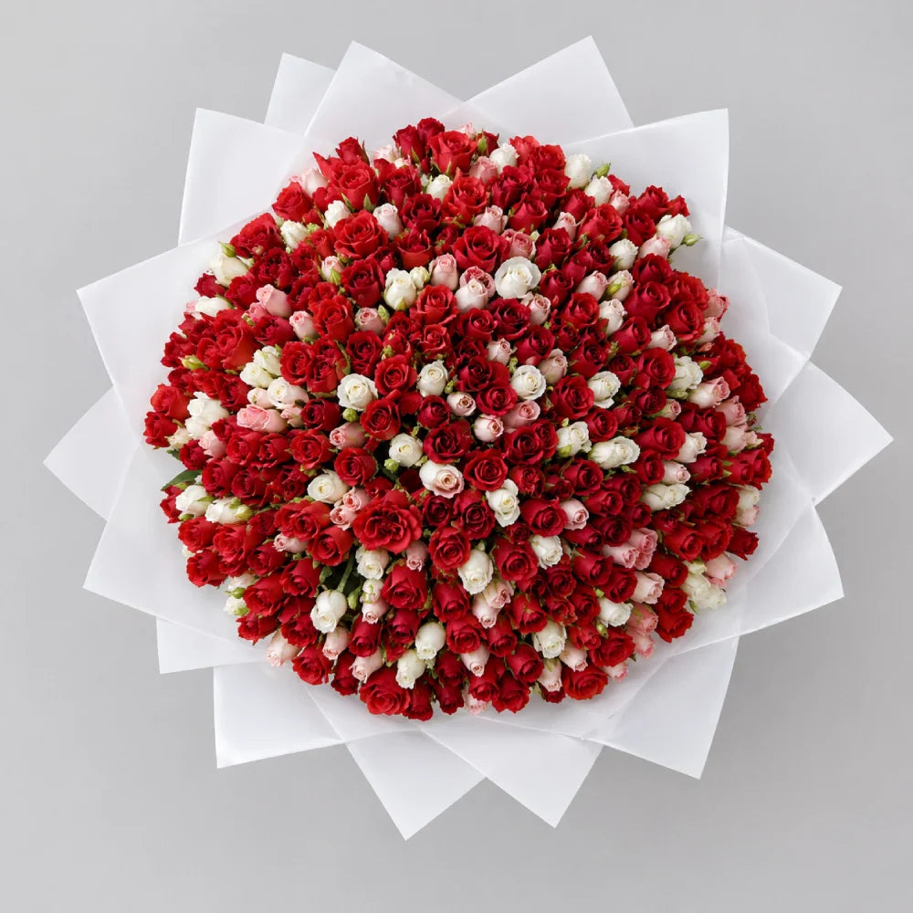 Bouquet of red and white flowers on a gray background