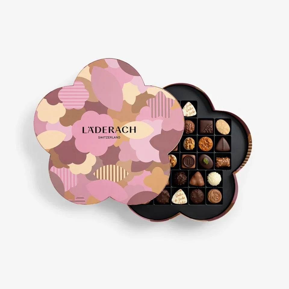 Heart-shaped chocolate box with Läderach branding on a light gray background