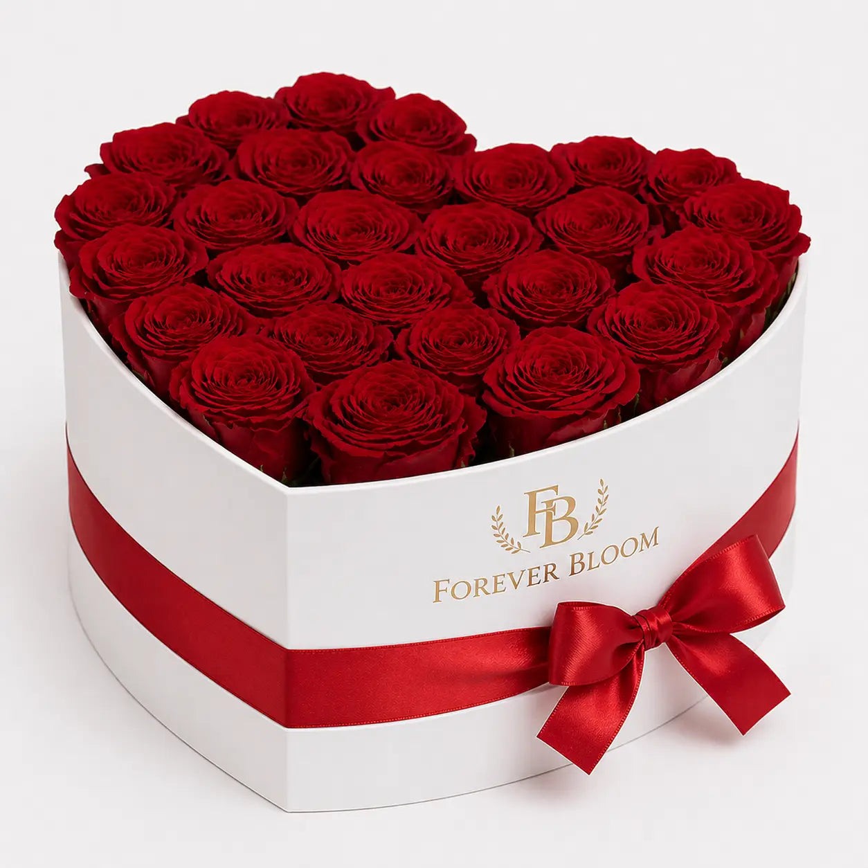 Heart-shaped box of red roses with a red ribbon and 'Forever Bloom' branding on a white background