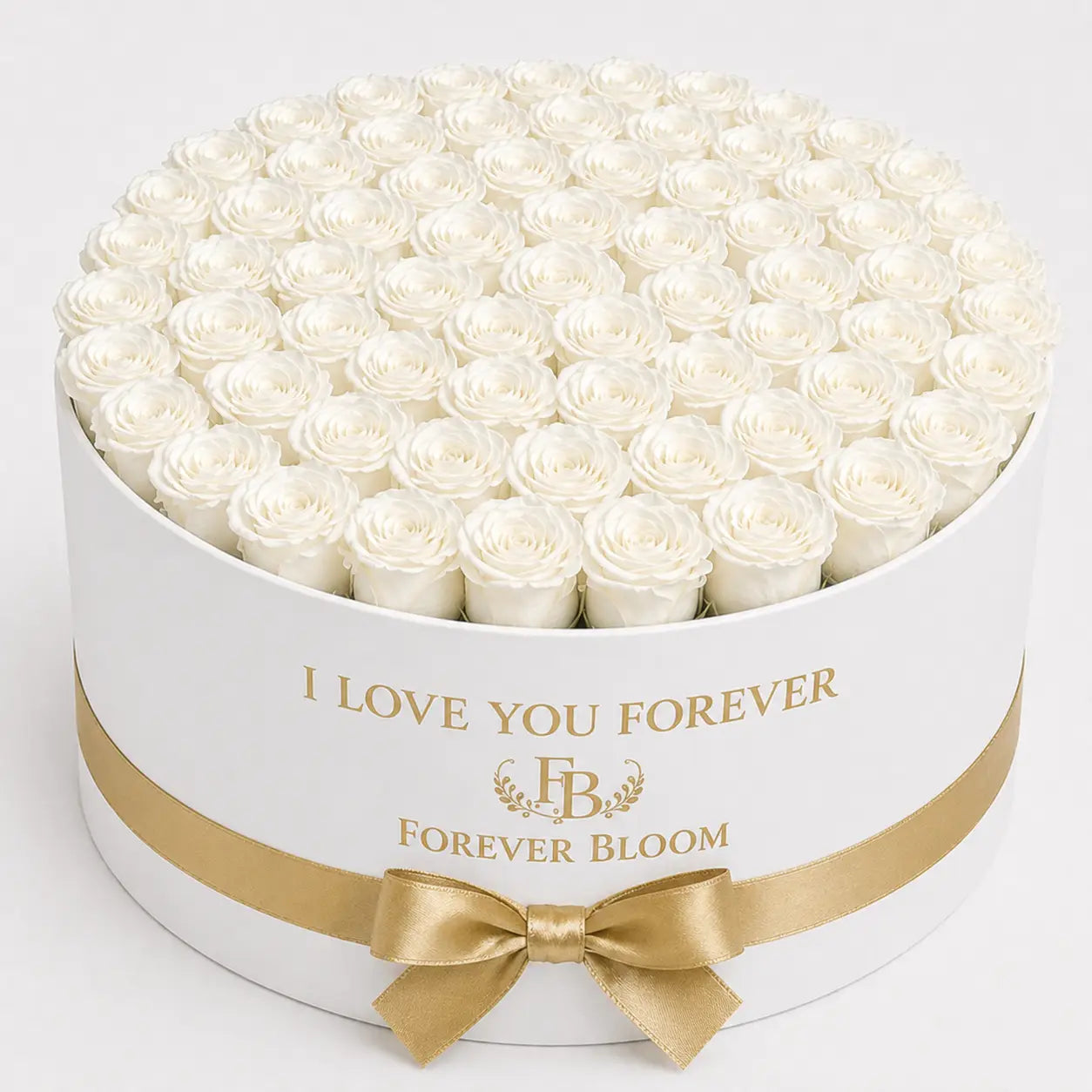 White roses in a round white box with gold ribbon and 'Forever Bloom' branding.