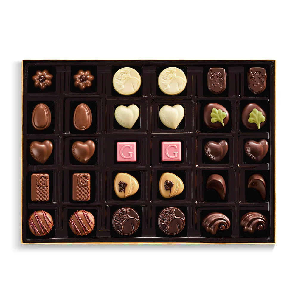 Assorted chocolates in a box on a white background