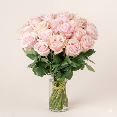 Bouquet of pink roses in a clear vase on a light background