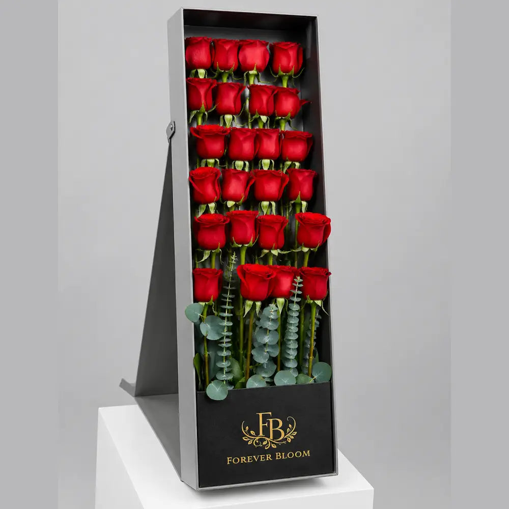 Box of red roses with 'Forever Bloom' branding on a gray background