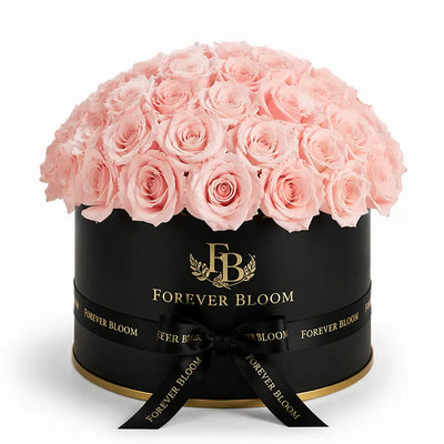 Black box with pink roses and 'Forever Bloom' branding on a white background