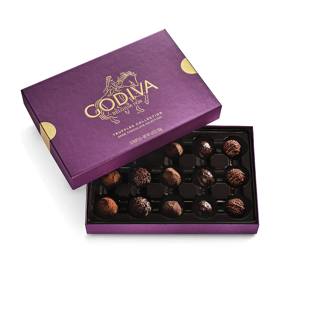 Open Godiva chocolate box with truffles on a white background