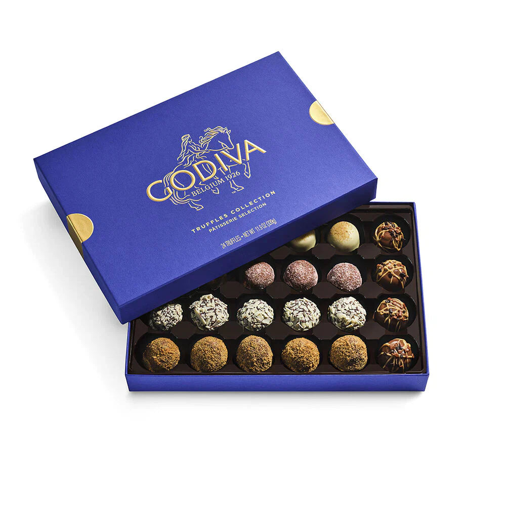 Open blue Godiva chocolate box with assorted truffles on a white background