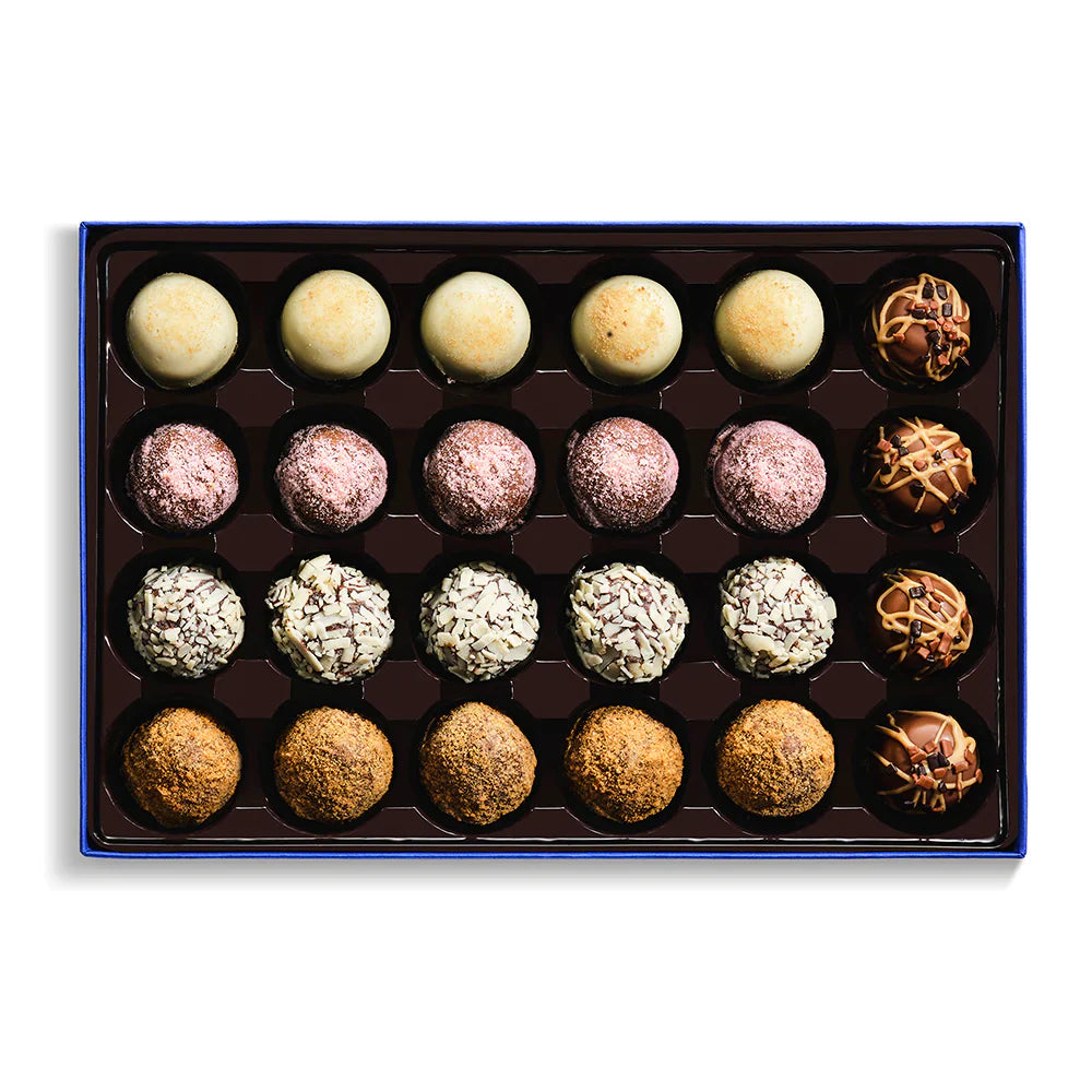 Assorted truffles in a box on a white background
