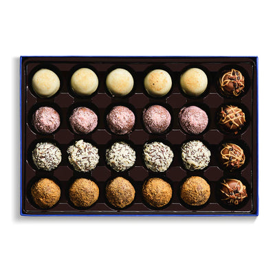 Assorted truffles in a box on a white background