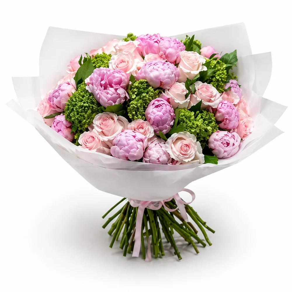 Bouquet of pink and green flowers wrapped in white paper on a white background