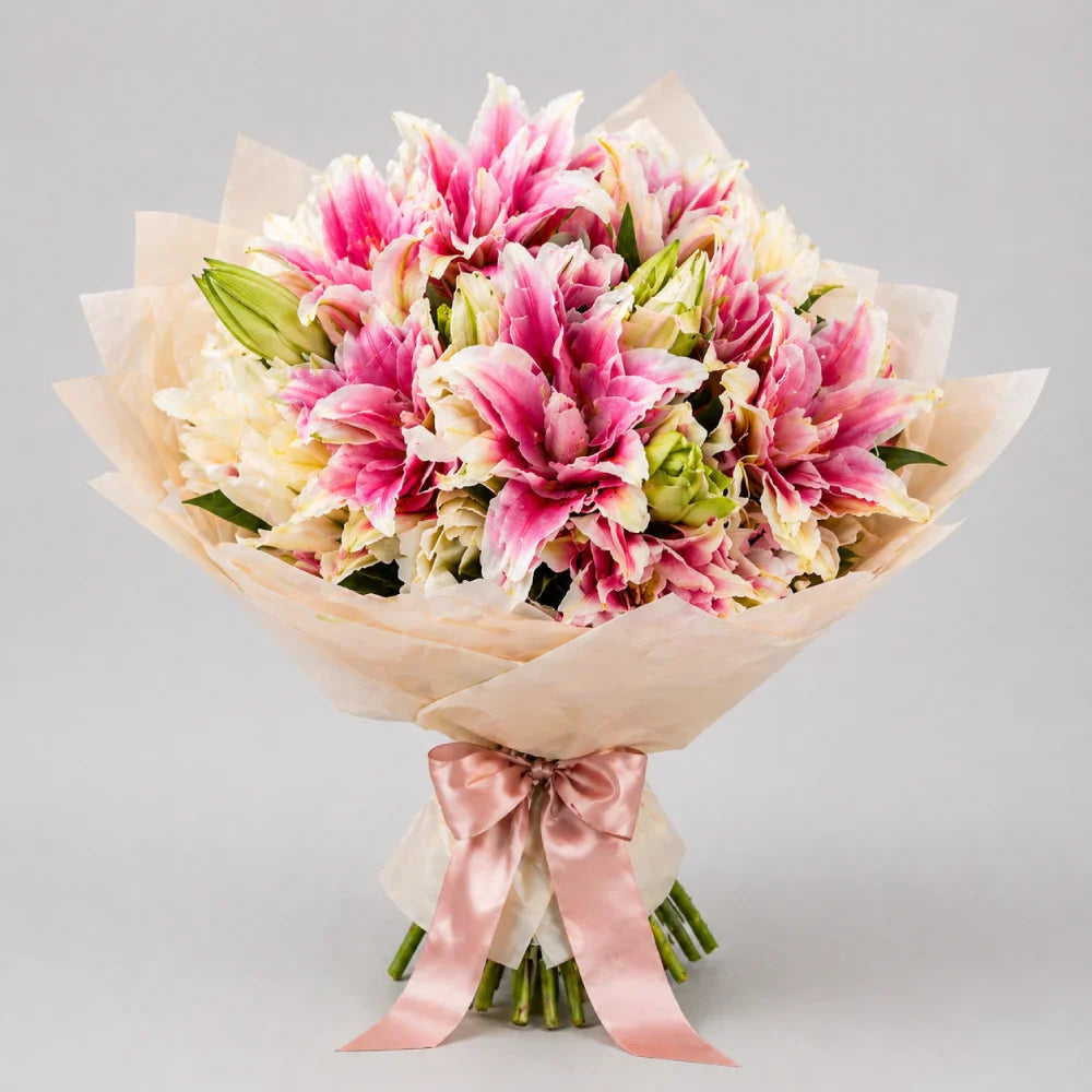 Bouquet of pink and white flowers with a pink ribbon on a light gray background