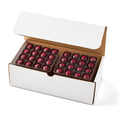 Open box of chocolates with a white background
