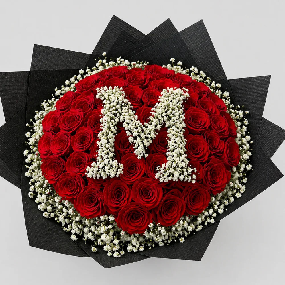 Bouquet of red roses with white letter 'M' on a black background