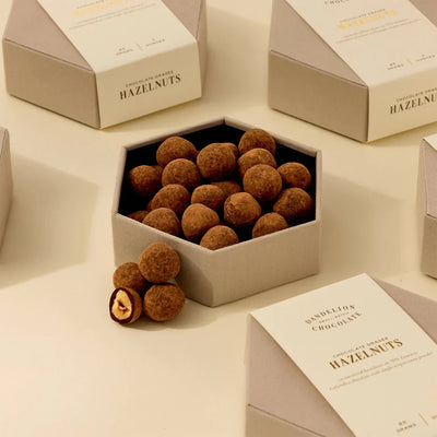 Hexagonal box of hazelnuts with a white box labeled 'Hazelnuts' on a light background